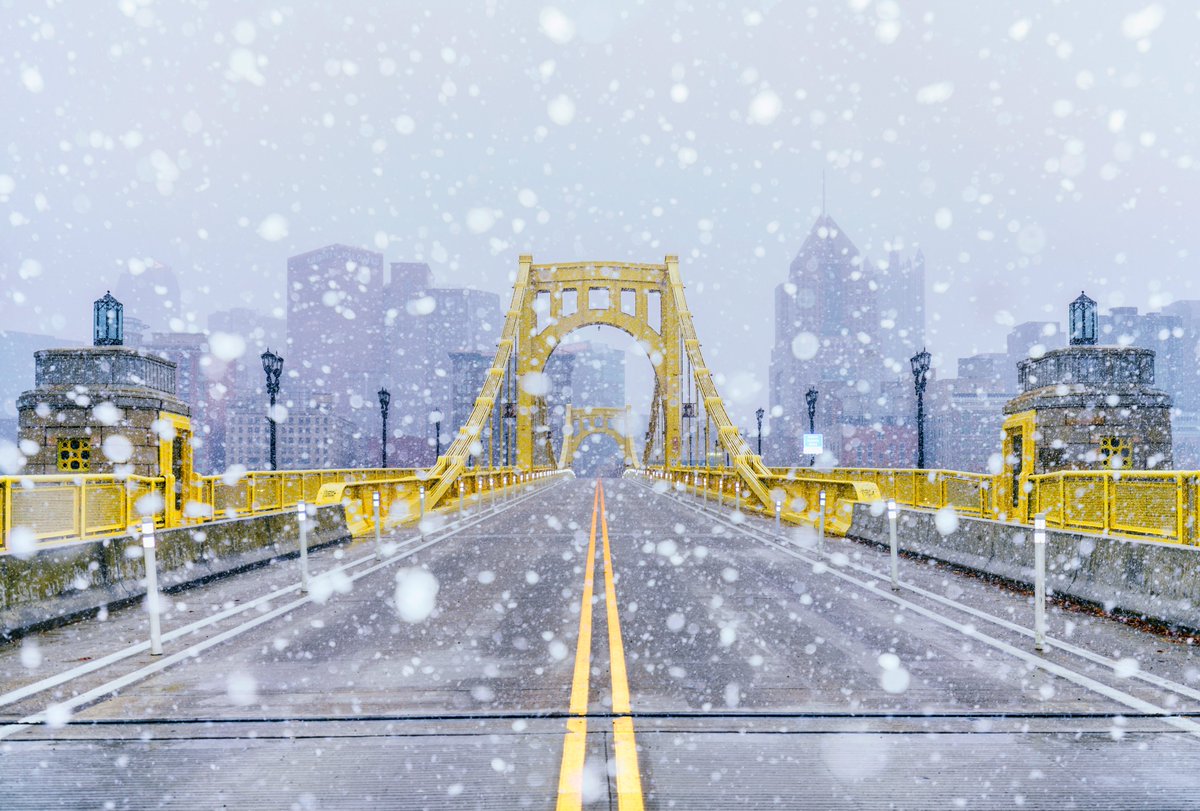 DaveDiCello's tweet photo. Another view from this morning's snow in #Pittsburgh, this time during the heaviest of the snowfall. The city was barely visible behind the Clemente Bridge, but the yellow of the bridge really stands out. Can't wait to get a real, actual snowfall this season. https://t.co/baHv0M96Qq