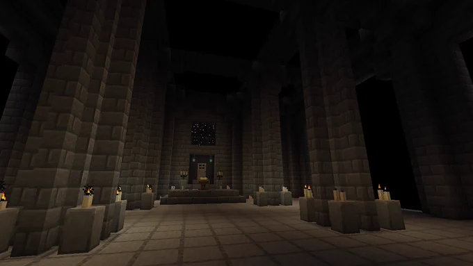 A screenshot of Minecraft depicting a dimly lit temple clad in grey bricks. Candles adorn pillars that arch up to struts along the roof. In the center of the image a platform with a lectern is visible, along with more candles and two candelabras. Behind it is an iron door, and above a square "window" of black blocks with glowing white "stars" in them is set into the wall.