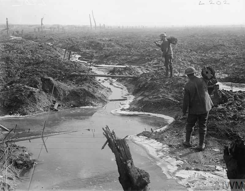 Troops carrying wire over ice and mud at Wieltje, near Ypres, 18 February 1918. IWM (Q 8512)