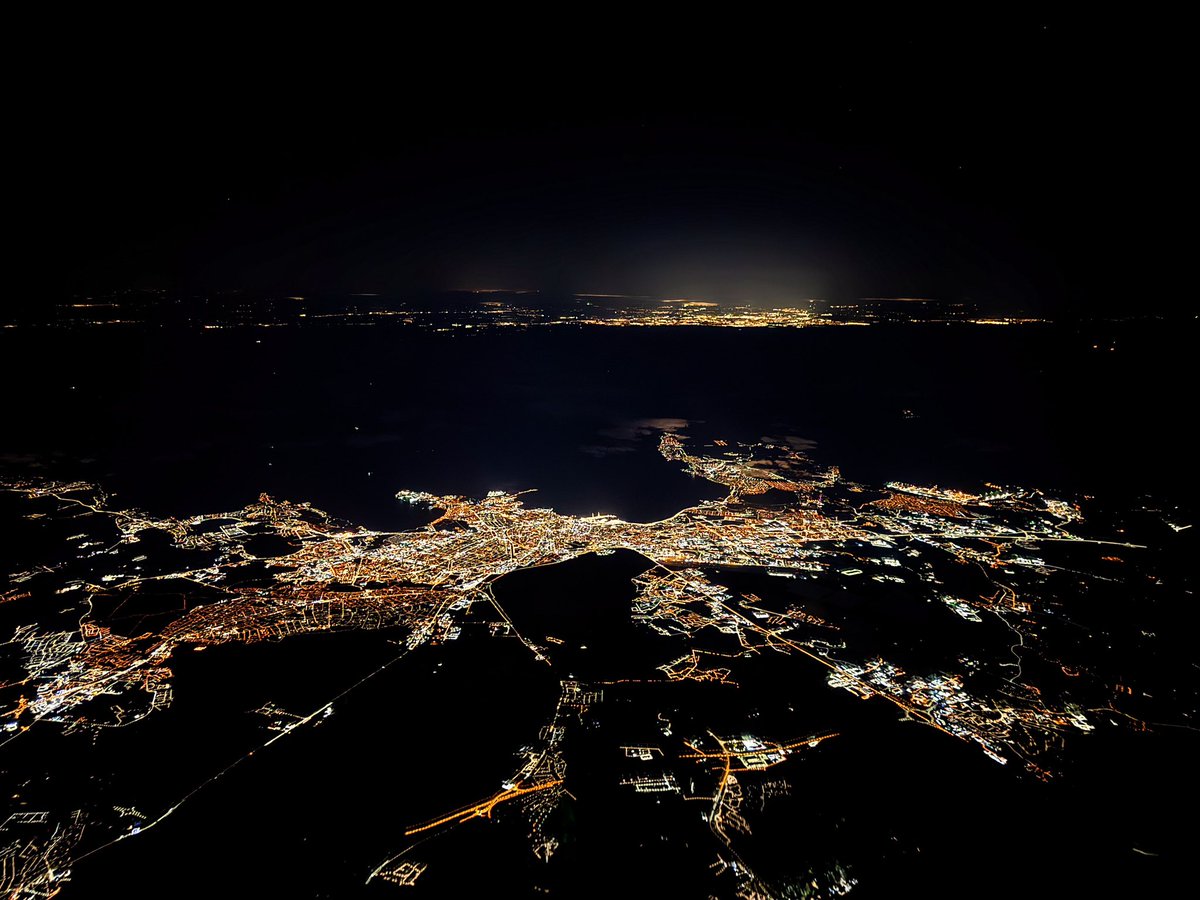 Tallinn by night, Helsinki on background.