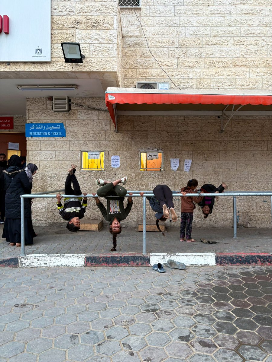 Sitting here, in-front of this group of displaced children at Al Aqsa Hospital, laughing and playing on the bars where people usually line up for treatment tickets. 

It hit me hard, and suddenly I was back in my childhood, at school in Beit Lahiya—a town that’s being wiped out