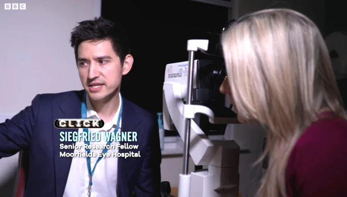 Dr Siegfried Wagner, senior research fellow at Moorfields, looks off camera at an OCT image, while Lara Lewington looks on.