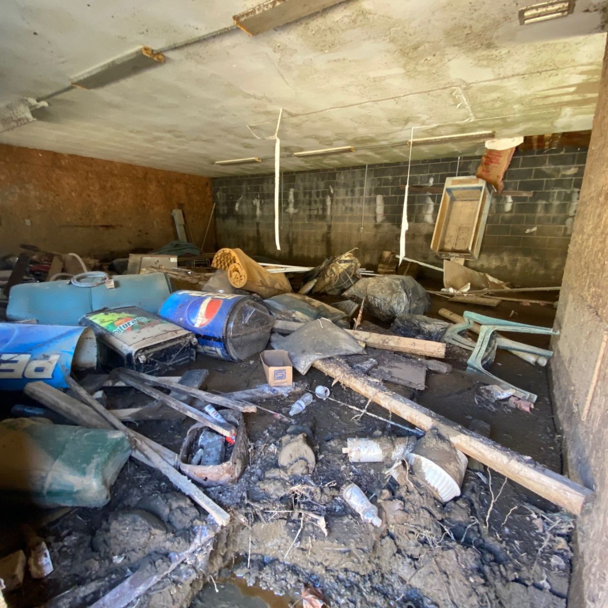 CarolinaBUILT's tweet photo. The Mountain Paradise Campground office basement was unrecognizable after Hurricane Helene—filled with debris and buried under 18 inches of mud. So, we got to work. Every piece of debris was picked out by hand, and skid steer equipment excavated the mud, restoring the space https://t.co/G1vbKR0lMR