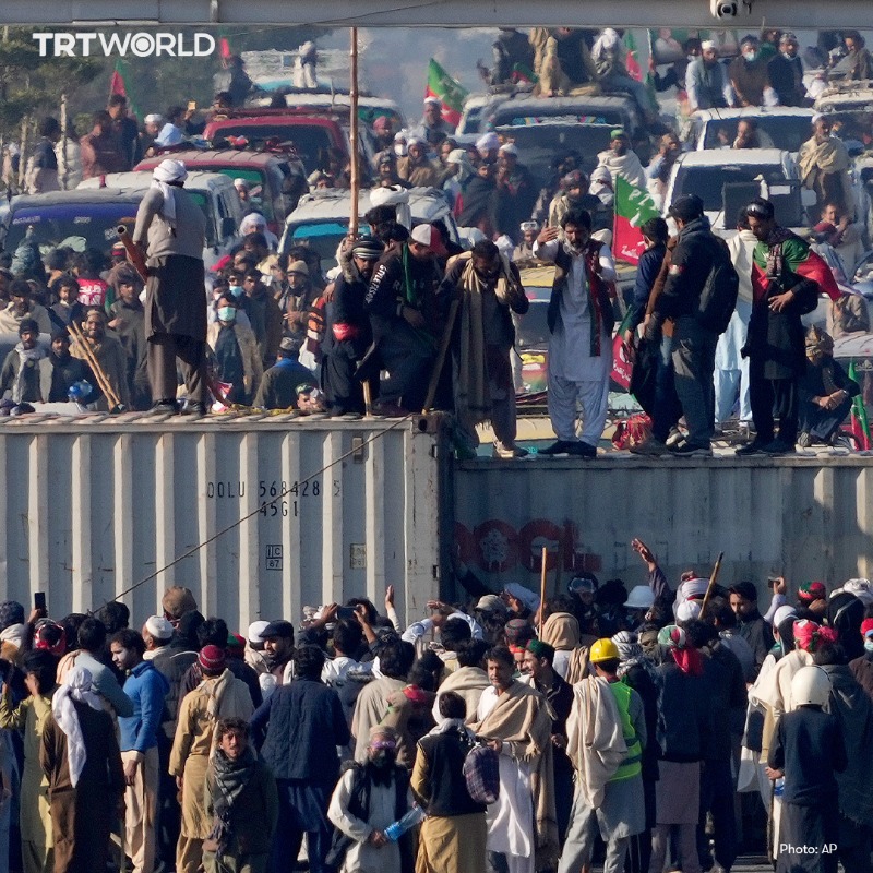 trtworld's tweet photo. Supporters demanding the release of jailed former Pakistani premier Imran Khan breached barricades of shipping containers sealing off Islamabad