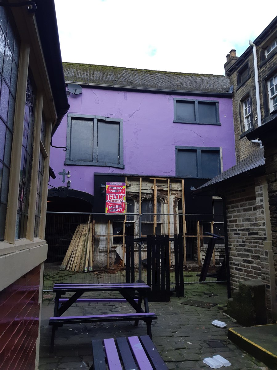 The entrance to Union Cross Yard in #Halifax has been fenced off for what appears to structural issuses on the neighbouring building. To gain access contractors have removed some wooden boards which have revealed what I believe is the original building frontage. <a href="/TrustCivic/">Halifax Civic Trust</a>