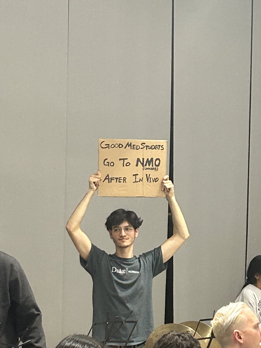 nmo_orchestra's tweet photo. NMO's very own sign guy, @sebastianesan, has a message to share. Come out to NMO's concert in Thorne Auditorium at 7:30pm after In Vivo! (Apparently all of the good med students will be there) https://t.co/Eass8Mq1Z0