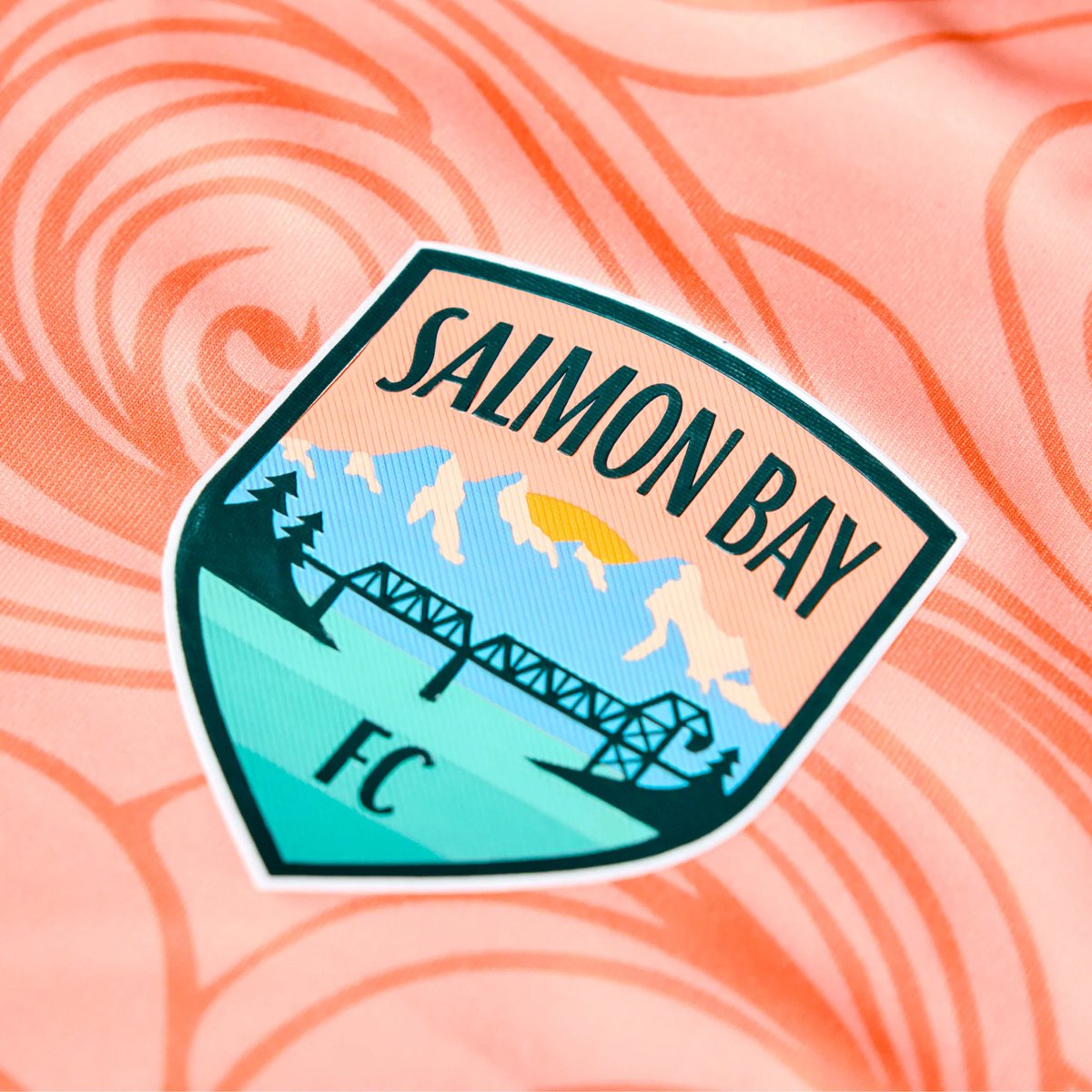 🌊| <a href="/SalmonBayFC/">Salmon Bay FC</a> Home

The inaugural home shirt for the women’s side takes local inspiration from the waters of the Salmon Bay.

Nice colour and a great look crest 👌