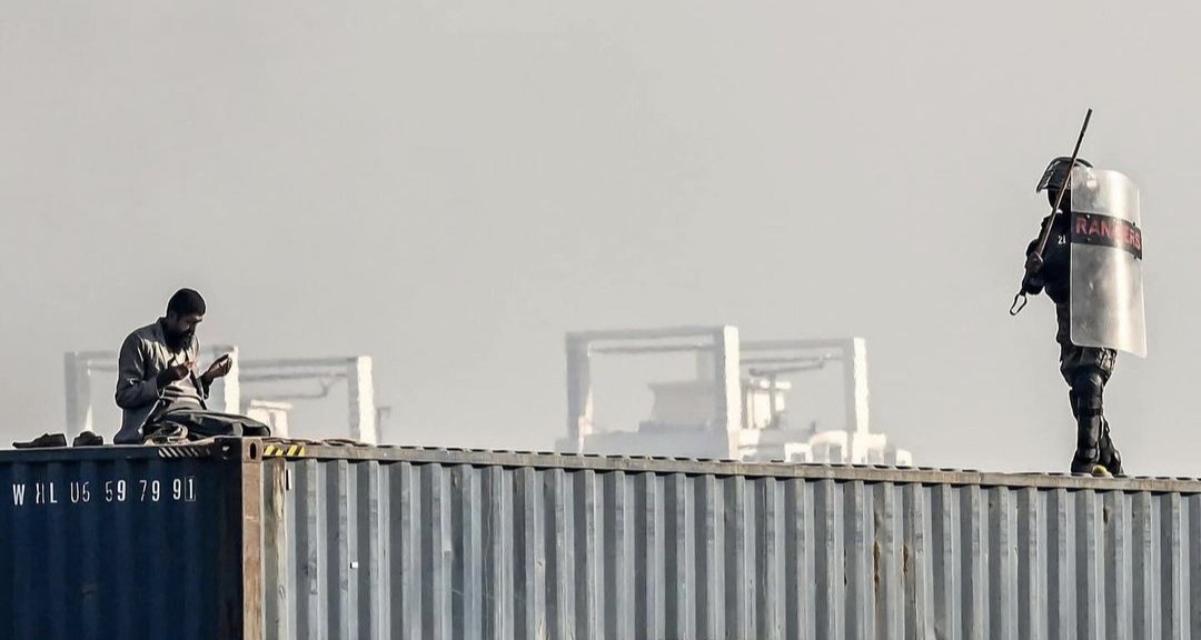 ImranArif007's tweet photo. A Protestant Offering prayer on top of the container was thrown off... 

An On-Duty state Ranger performing his duty diligently as per orders.

Not sure who did the right thing.

"Justice shall be served on the day of judgement because Allah Almighty is listening &amp; watching." https://t.co/KkgEs4BKnY