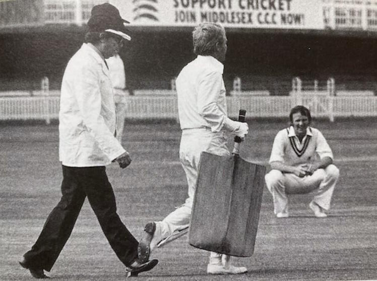 The batsman with the oversized implement is Ernie Wise, hotly pursued by umpire Eric Morecambe - the bemused looking fielder is Dennis Amiss