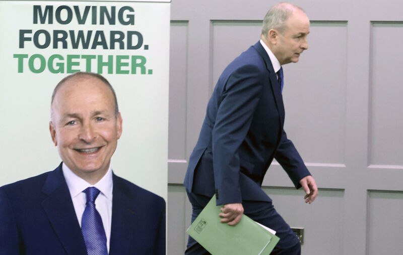 Big Mickey Jumps Into The Lead. Tánaiste and Fianna Fail leader Micheál Martin appears to jump out of his poster as he heads for the door after a press conference in Dublin today. He was anxious to get on the road after he outshone Simon Harris on the RTE Leaders Debate last