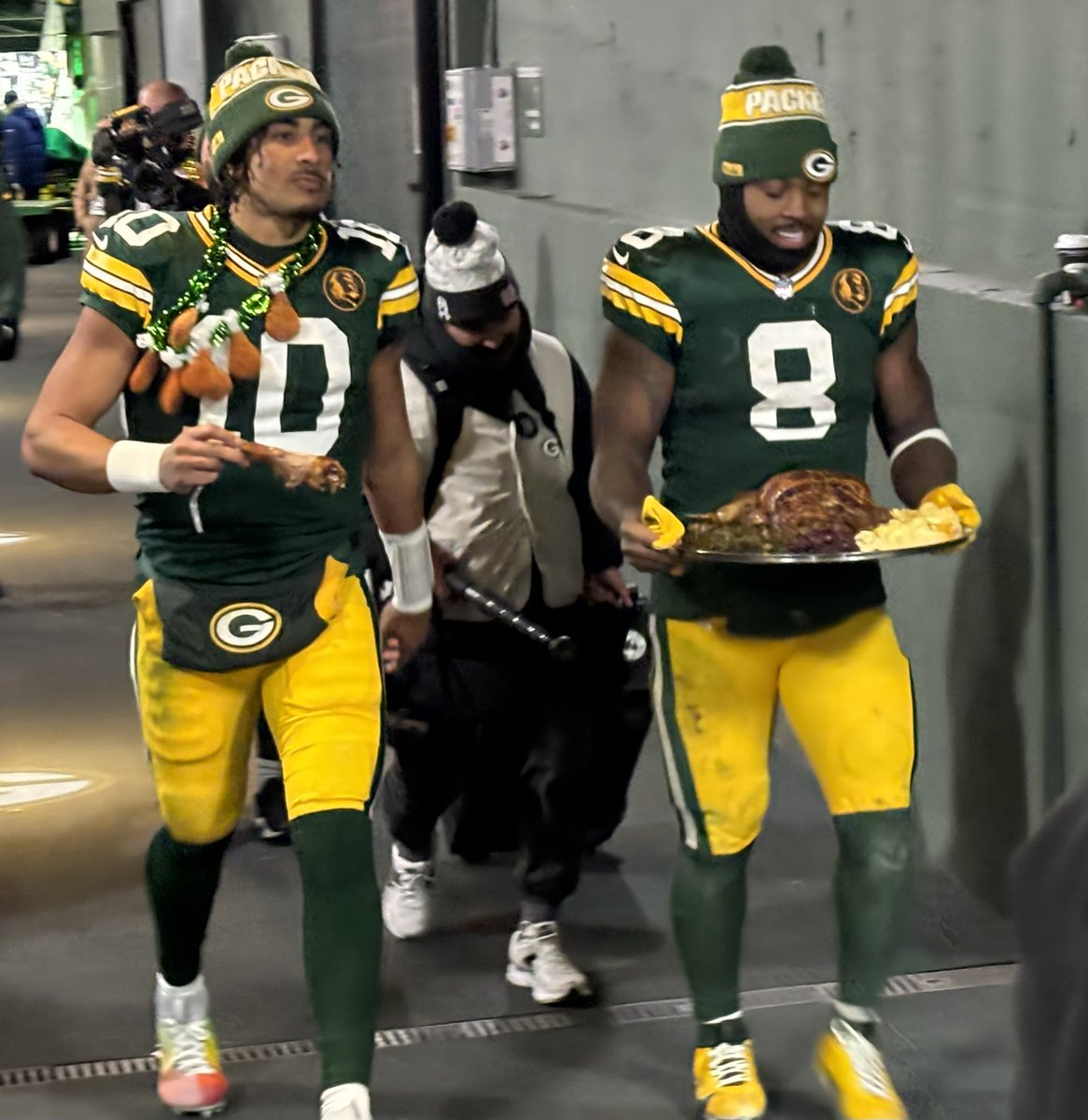 Josh Jacobs, along with Jordan Love, bringing a postgame meal back to the locker room after #Packers' victorious #Thanksgiving rout of #Dolphins. #JohnMaddenThanksgiving