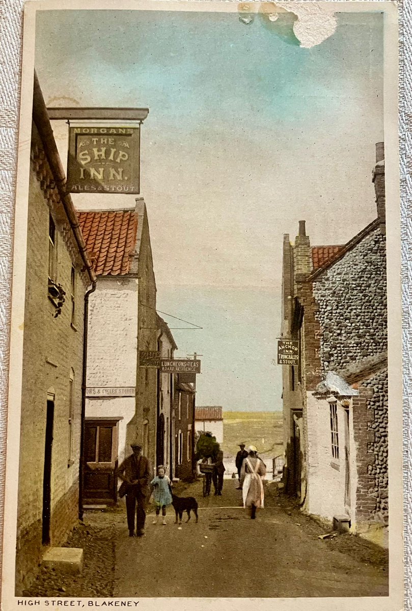 An old photo from our archives of Blakeney High Street looking down towards the harbour. Not certain if the photo shows 2 or 3 drinking establishments but now there is only one here now - The White Horse. #WeAreLocalHistory #Norfolk