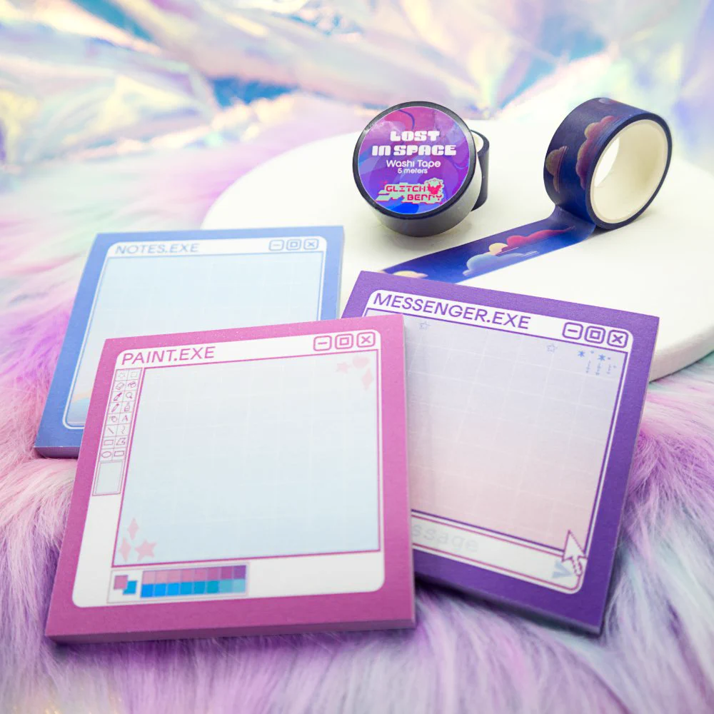 Photo of stationery, including three blue, pink, and purple sticky notes designed after computer programs, and washi tape with space and cloud patterns on it