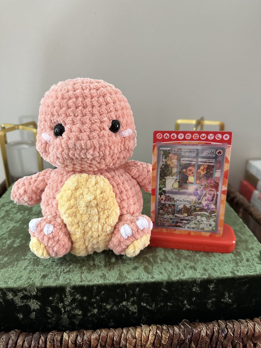 Hannah made me a crochet charmander and I have my favorite card displayed next to it!