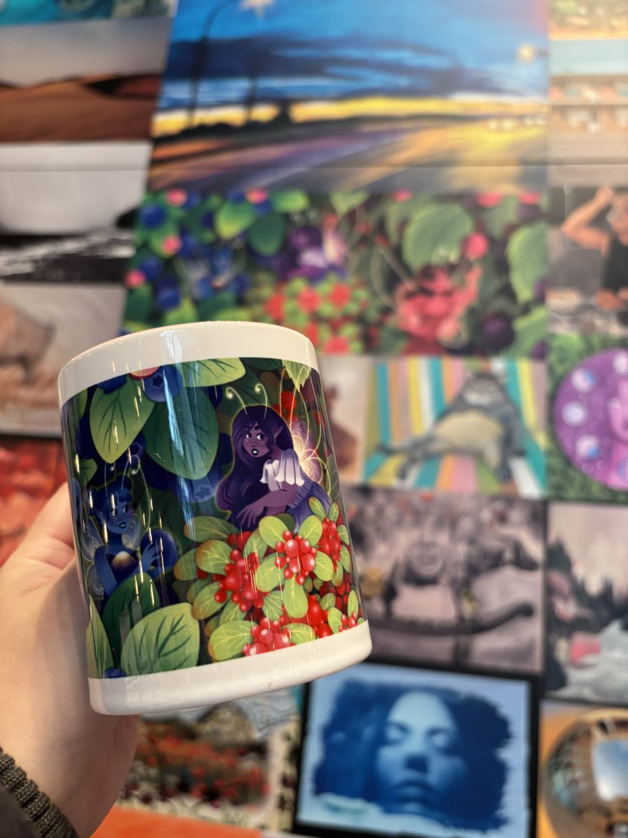 My fairy art <a href="/yourAGA/">Art Gallery of Alberta</a> next to the mugs I brought for the market this weekend! It’s still very cool to see my work up for everyone to see!