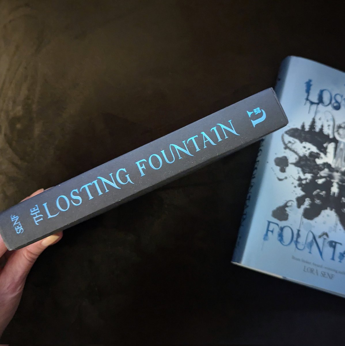 Lora Senf (@lora013) on Twitter photo One month until THE LOSTING FOUNTAIN creeps into the world. YA dark fantasy, 14-17 y/o MCs, themes of loss, home, and searching for the place you belong. Signed copies available from <a href="/auntiesbooks/">Auntie's Bookstore</a> and <a href="/WishingTreeBook/">Wishing Tree Books</a>.
Preorders and library requests mean a lot. 🖤
Out 12/31/24 One month until THE LOSTING FOUNTAIN creeps into the world. YA dark fantasy, 14-17 y/o MCs, themes of loss, home, and searching for the place you belong. Signed copies available from <a href="/auntiesbooks/">Auntie's Bookstore</a> and <a href="/WishingTreeBook/">Wishing Tree Books</a>.
Preorders and library requests mean a lot. 🖤
Out 12/31/24