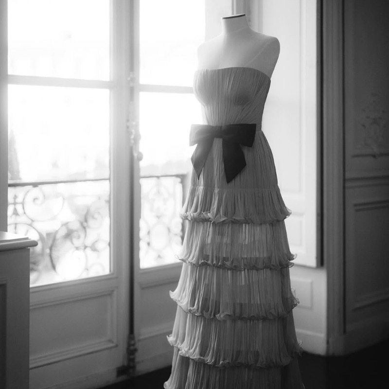 MaisonValentino's tweet photo. For 'Le Bal des Débutantes' in Paris, Apple Martin wore a custom #ValentinoHauteCouture gown by Creative Director #AlessandroMichele. Crafted from ciel bleu silk plissé chiffon, the dress features intricate vertical pleats and a black silk bow at the waist.