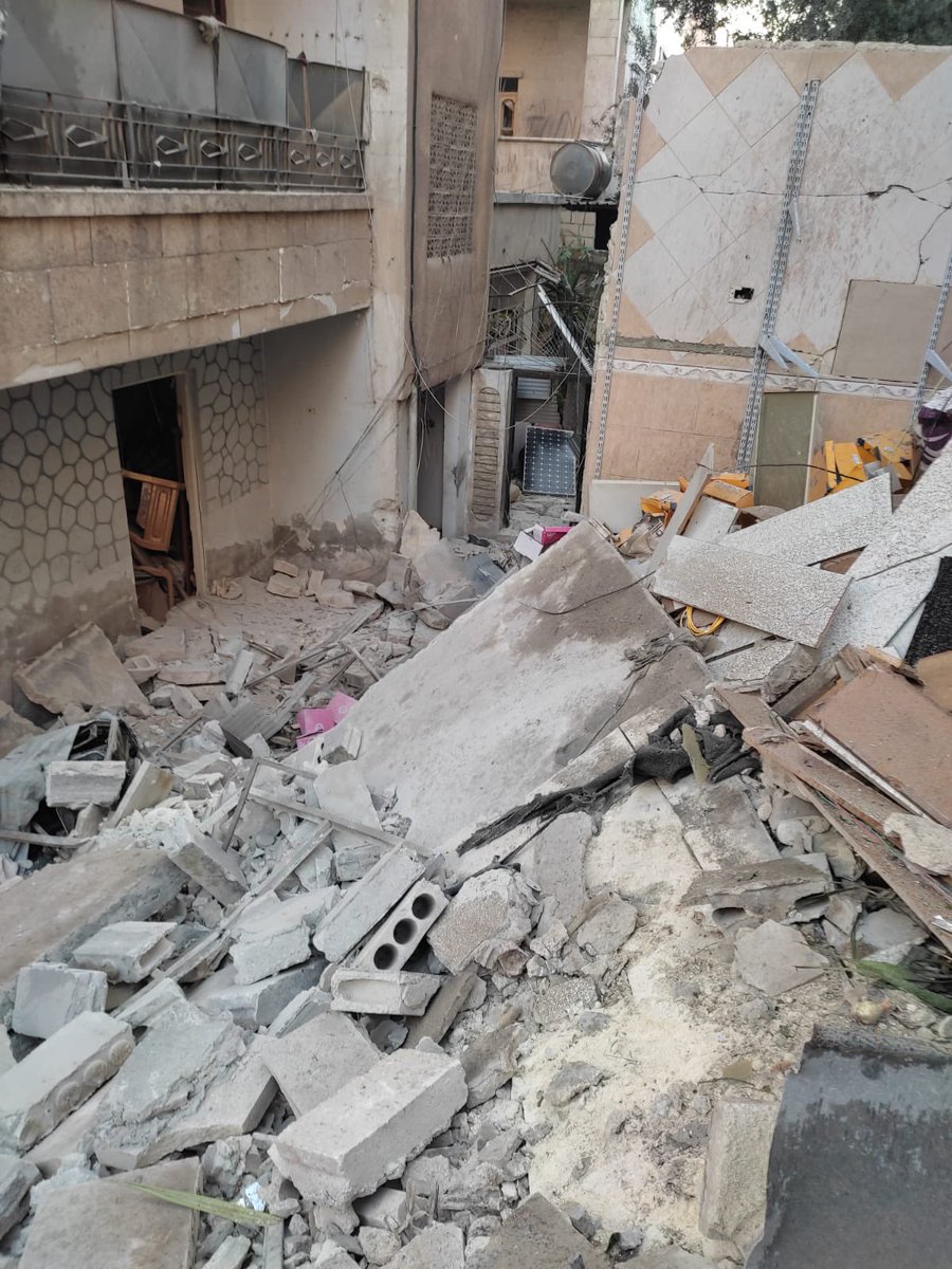 ZainaErhaim's tweet photo. This is my grand parents’ home in #Edlib after being bombed by the syrian regime. I lived here most of my childhood. That loquat tree behind the door was my hiding place when my gramma wanted to feed me something I didnt like. On the left is Abu-Zuheer’s house, they were Kurds. https://t.co/I7p1OOVEh9