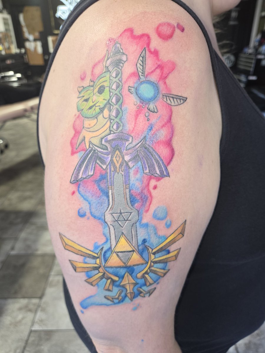 AnimeJessica's tweet photo. It took everything I had to not post this before my followup appt to get the background. The main design I got a month ago! This Legend of Zelda tattoo turned out absolutely perfect! The watercolor background was exactly what this design needed! https://t.co/kjyfErTFAt