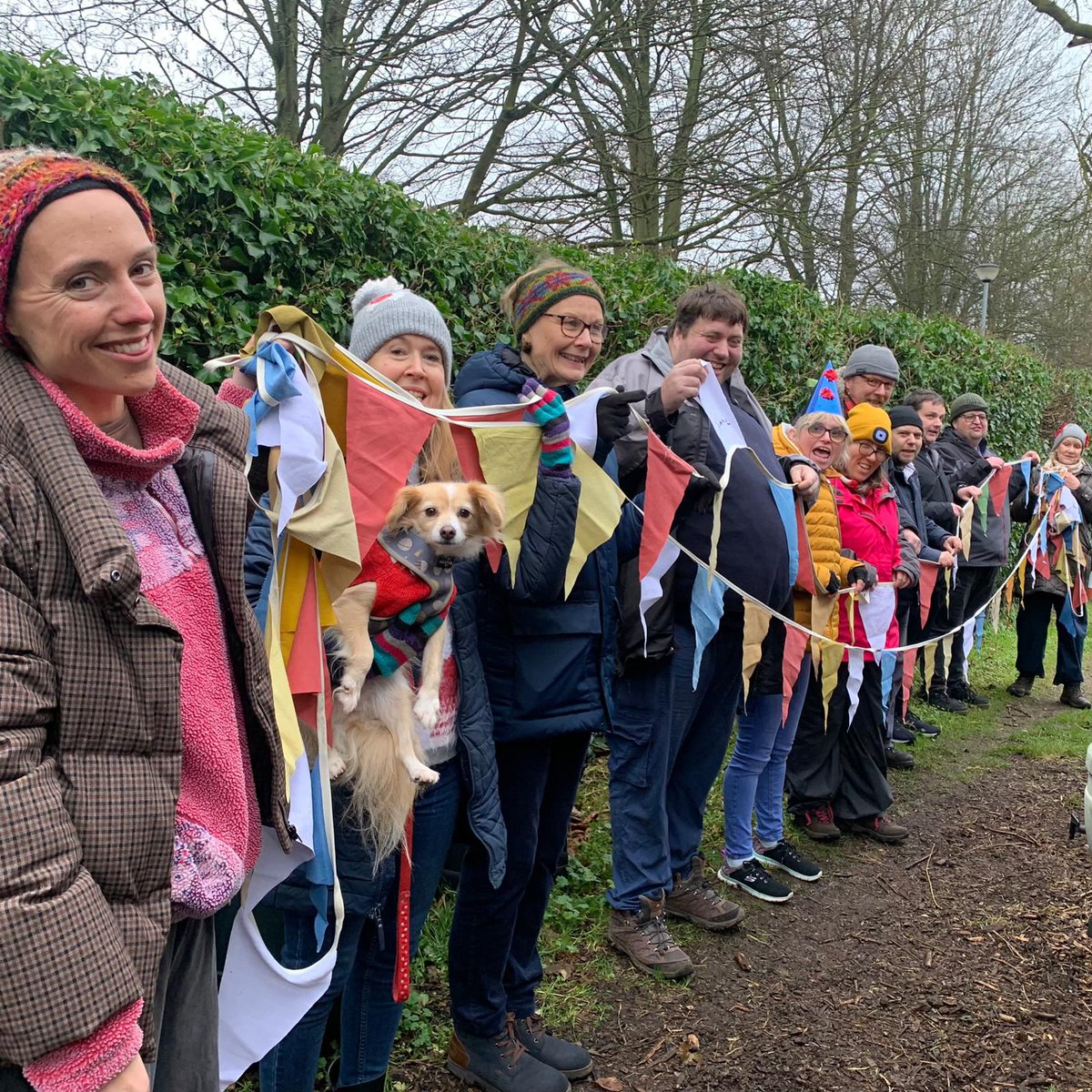 The growing Ability team show off the plant dyed bunting Susan helped them create.