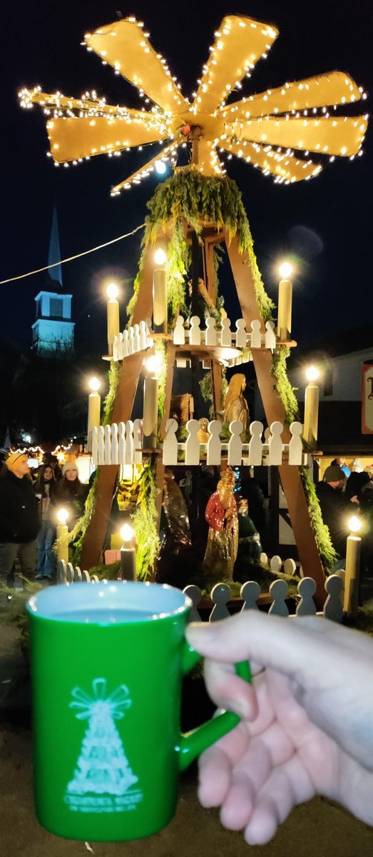 Is showing off your Christmas Market mug in front of the landmark or other highlight pictured on it a tradition of only Germany? It doesn’t have to be, <a href="/CeliaBedelia/">Celia</a>  and other adherents!

The white #Glühwein (the only option) was excellent! #Mifflingburg 2024 #ChristkindlMarket