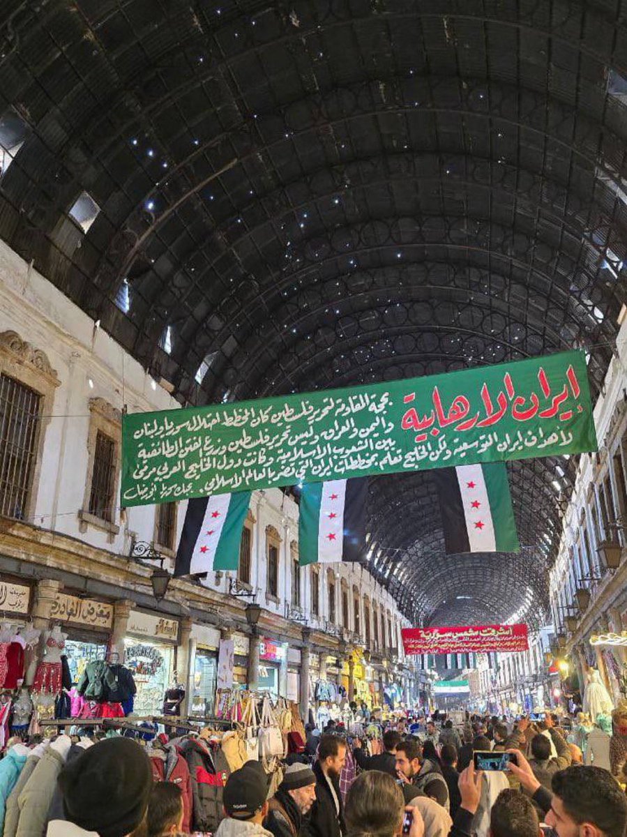 Damascus shop owners display a banner stating:

“Iran exploited Palestinian resistance to spread sectarianism in Arab nations, but the plot is now exposed.”