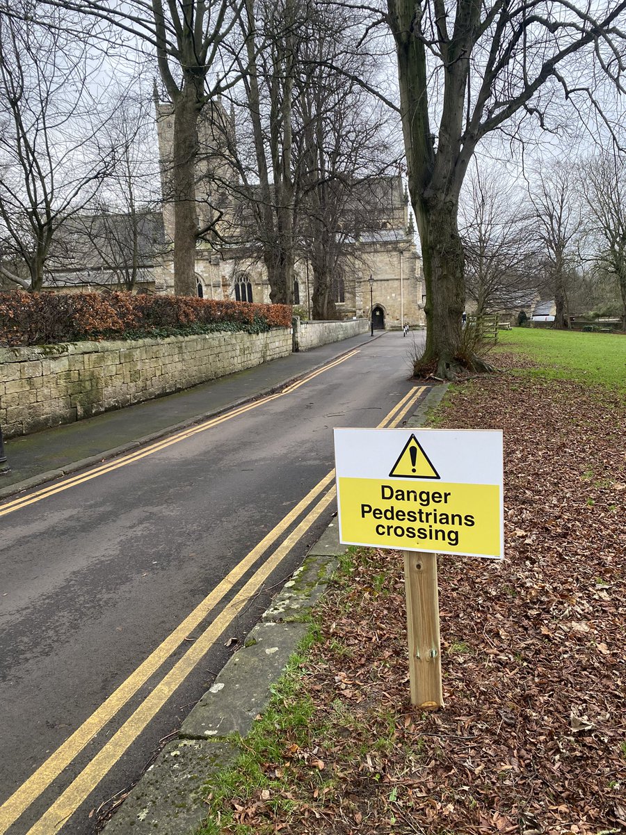 The parish church driveway now sports signs reading “Danger: Pedestrians Crossing”. 
It’s a thoughtful gesture, but are we protecting pedestrians… or warning motorists?
