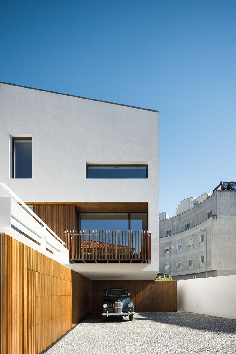 Archello's tweet photo. Casa Forca-Vouga by RVDM Arquitectos merges topography with design. A floating white monolith with wood-accented voids sits atop an excavated basement, blending exposure and enclosure. 
https://t.co/6B3QqD6LSP

#TopographicDesign #ModernMonolith #SustainableArchitecture https://t.co/Yjr8T9kt3I