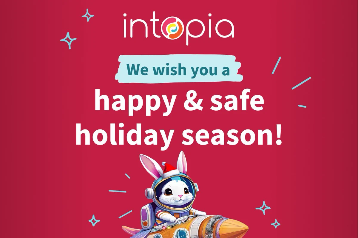 We wish you a happy & safe holiday season! Astronaut bunny with a Santa hat atop their helmet, in a rocket ship decorated with tinsel and Christmas lights. Intopia logo.