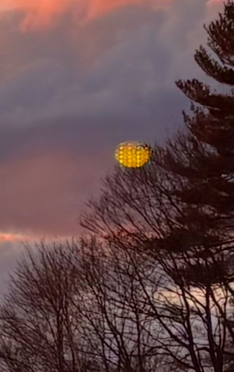 Mike_McCarron's tweet photo. On Thursday afternoon December 12th at 4:05pm, I was finishing up a walk in the woods in North Andover, MA and stopped to take in the awe-inspiring sunset and skyline. Only after did I notice what was captured near the trees. Not the moon (behind me) or manipulated in any way….. https://t.co/BeRrvQJnvz