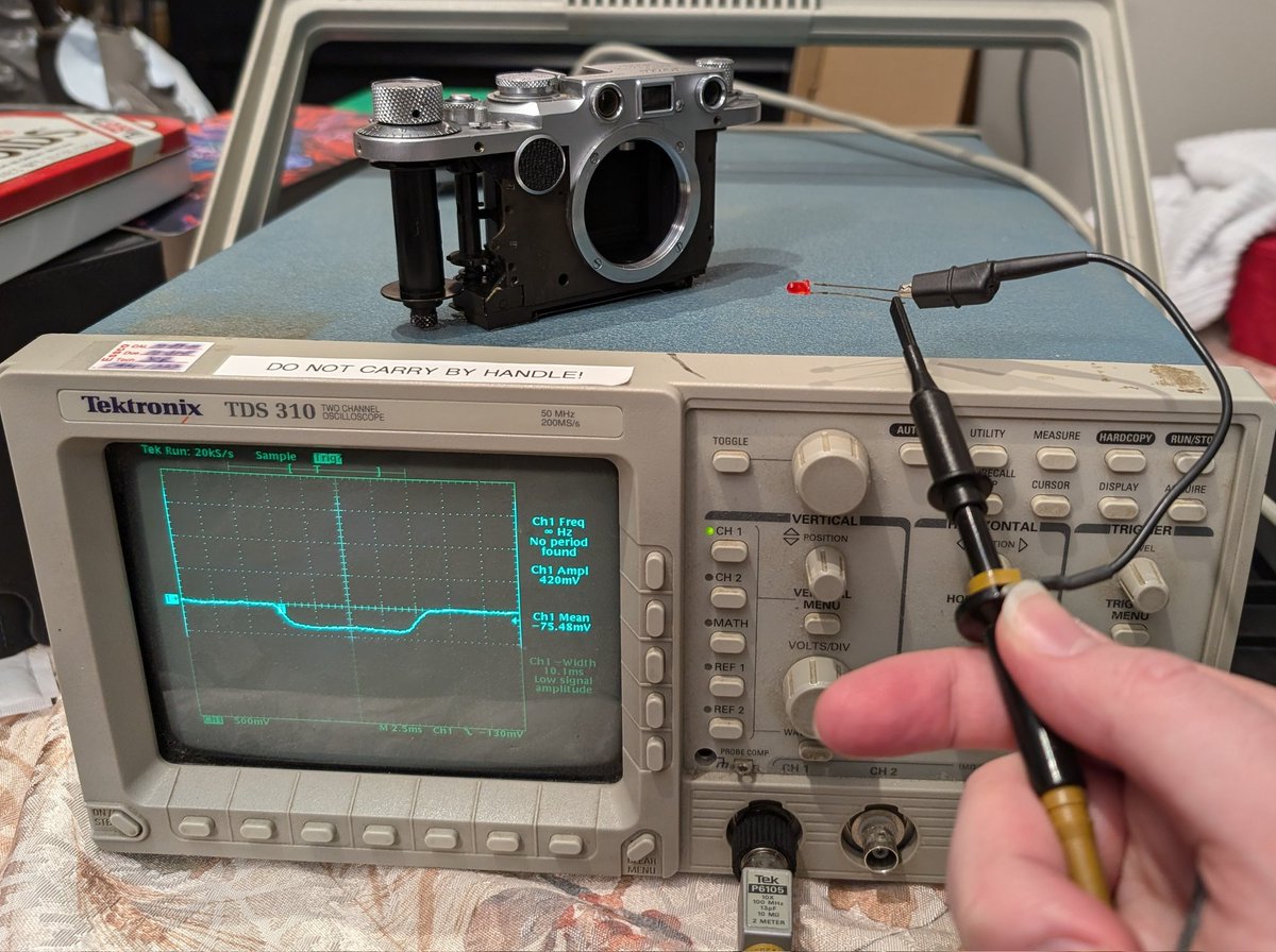 Fun fact: LEDs act as tiny little solar panel, which means you can hook one up to an oscilloscope and use a flashlight to measure the shutter speed of a camera :)

Did some TLC on my dad's old Leica 2f and its shutter is still 💯