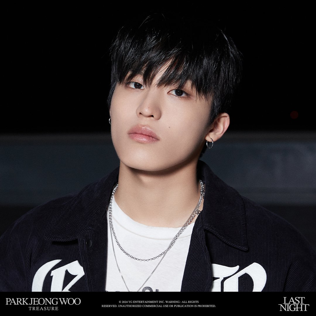 Every detail, from the layered chains to the subtle glint of the earrings, speaks volumes about effortless elegance and attention to detail. His gaze, both intense and contemplative, captures the essence of resilience and depth.