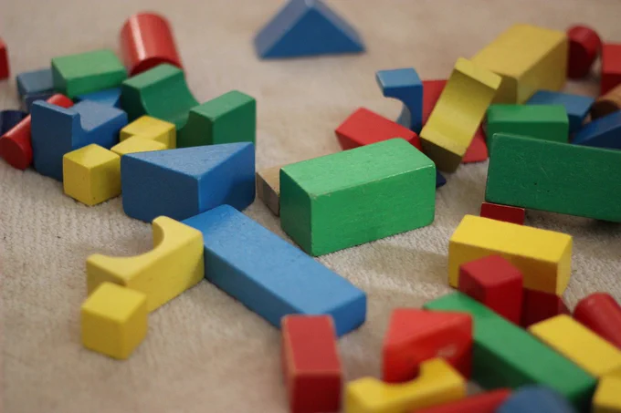 Image shows lots of wooden blocks of various shapes and colours, all waiting to be sorted and organised. Or played with. Either way, it's a visual metaphor for 'data management'.