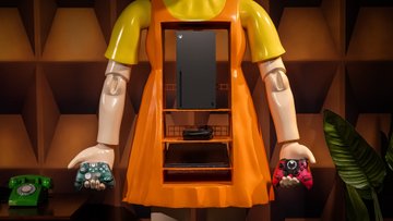 Close up image of the Squid Game Young Hee Gaming Cabinet holding the Squid Game Game Over Controller in the left hand and holding the Squid Game Pink Guard controller in the right hand Inside the cabinet is an Xbox Series X a ROG Ally X Black Handheld Gaming Device and a Lenovo Legion Slim 5 Gen 8