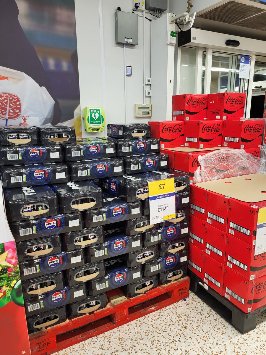Whoosher's tweet photo. @Tesco Access to the defibrillator completely blocked at your Dinnington store - again! If there's an incident and it's required, every second counts  to save someone's life. I've called this out before and it's really not acceptable. Leaving a small gap at the side doesn't help. https://t.co/ukleqH4nC1