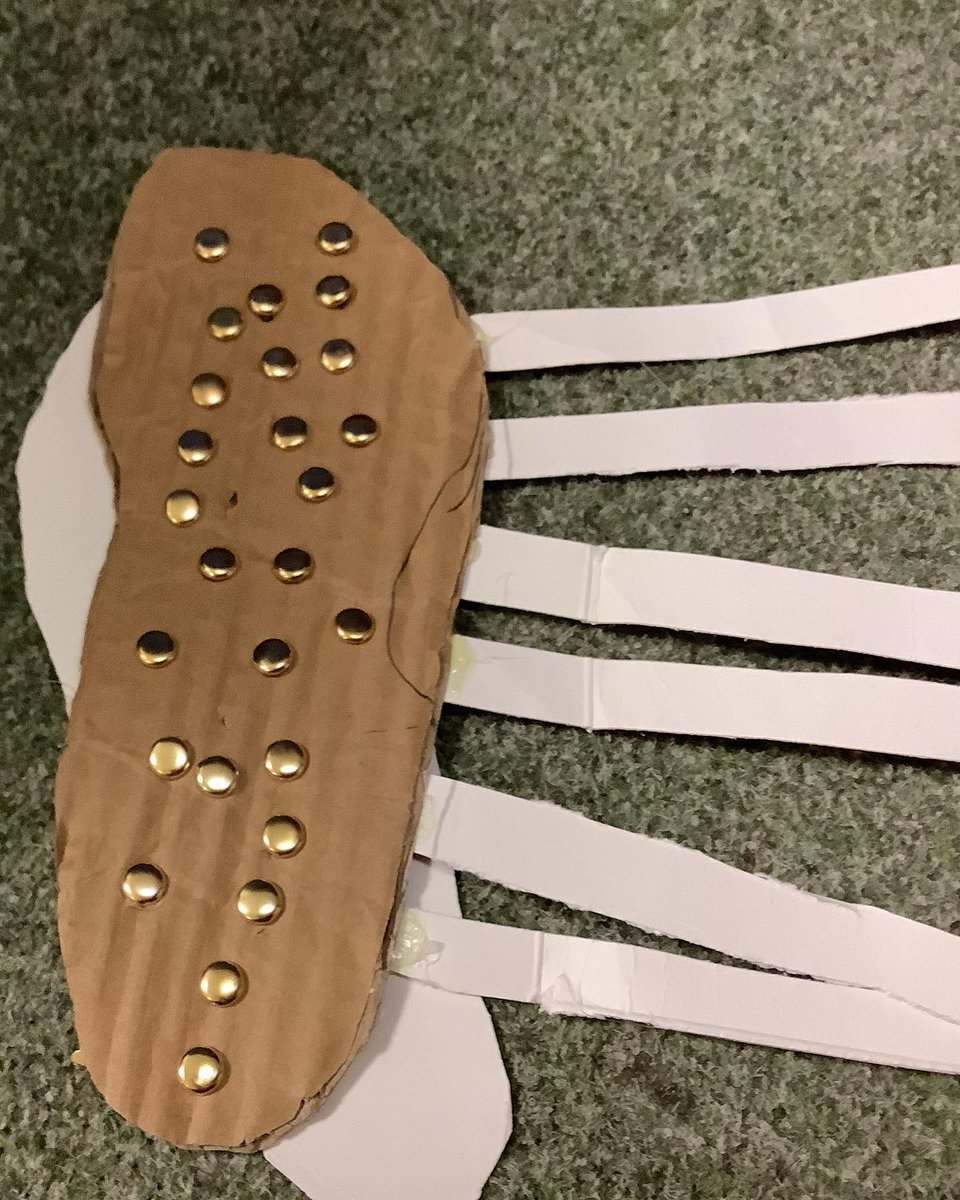 nlancingprimary's tweet image. "We're learning about Romans &amp;amp; we made a sandal! We cut cardboard to make the base &amp;amp; glued cardboard to make straps. We hole punched them &amp;amp; threaded string through &amp;amp; tied them. We tried them out,walking down the corridor to see if the shoe would stay in one piece - some did not!"