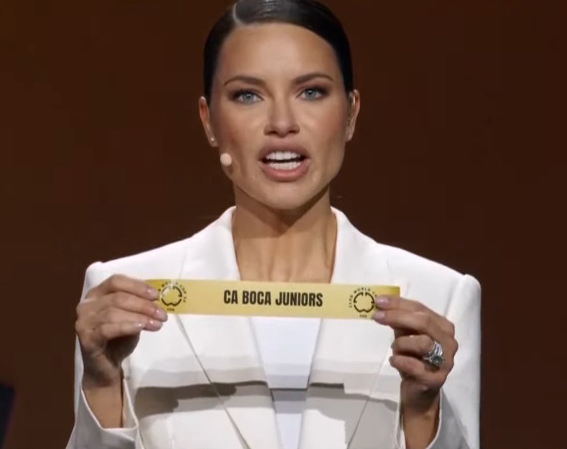 adriana lima sosteniendo un papel de boca juniors vivimos en una simulacion