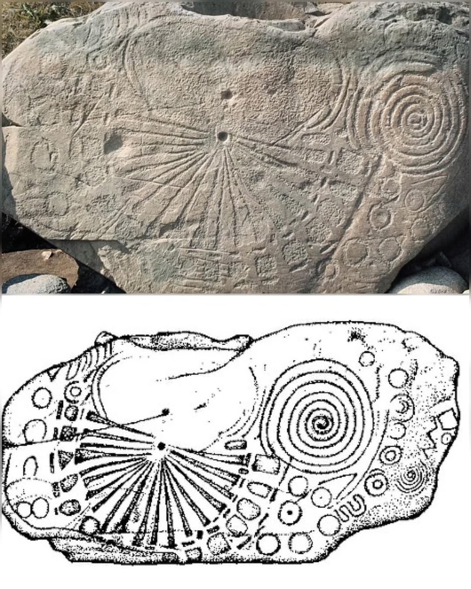 Kerbstone 15, a 5,000-year-old Neolithic artifact at the Knowth passage tomb in Ireland’s Boyne Valley, is carved with intricate designs including a central cupmark with 20 radiating lines, spirals, and U-shaped motifs. 

One of 124 kerbstones surrounding the site’s main mound,