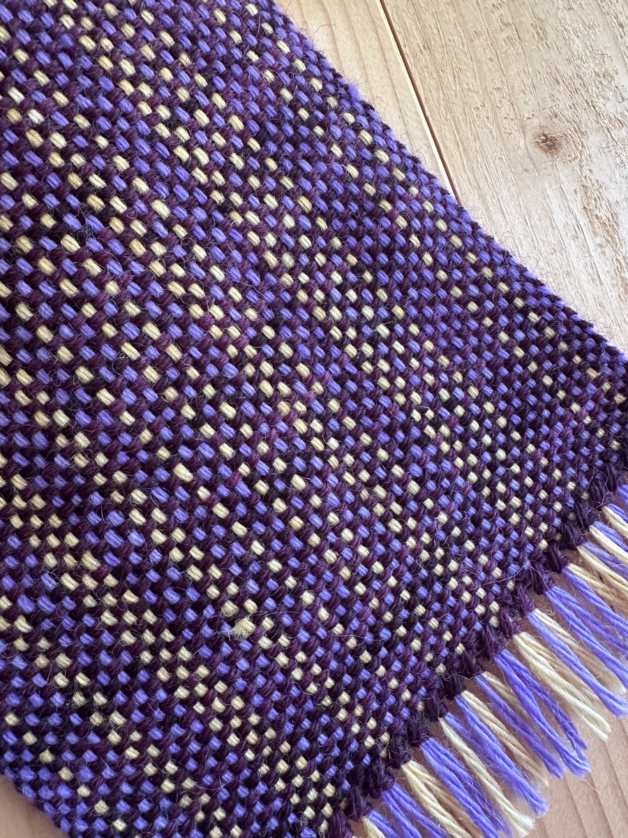 Gleaming in purple and gold, is handwoven in rich, hand-dyed shades using pure fibres that won’t itch.

justwooltextiles.co.uk