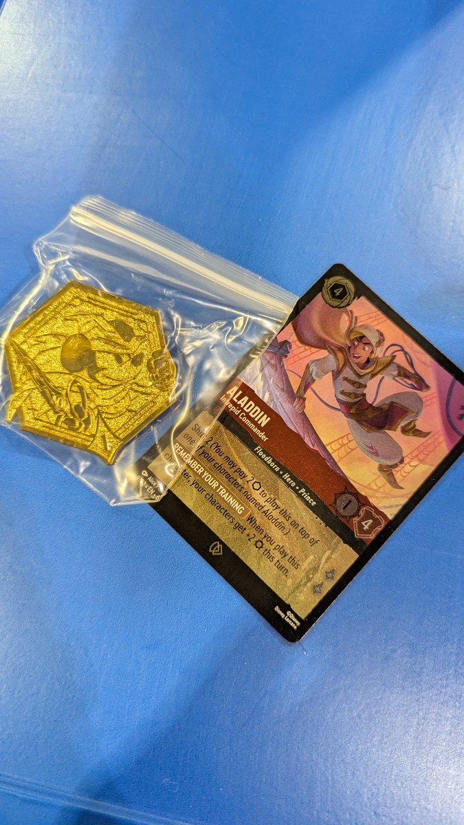 DisneyLorcana's tweet photo. At PAX Unplugged? Stop by the Ravensburger booth #2021 for exciting con exclusives! Every purchase of Disney Lorcana products comes with a promo card and Mickey Mouse Brave Little Tailor pin (while supplies last) https://t.co/NgT7Xz3hMQ