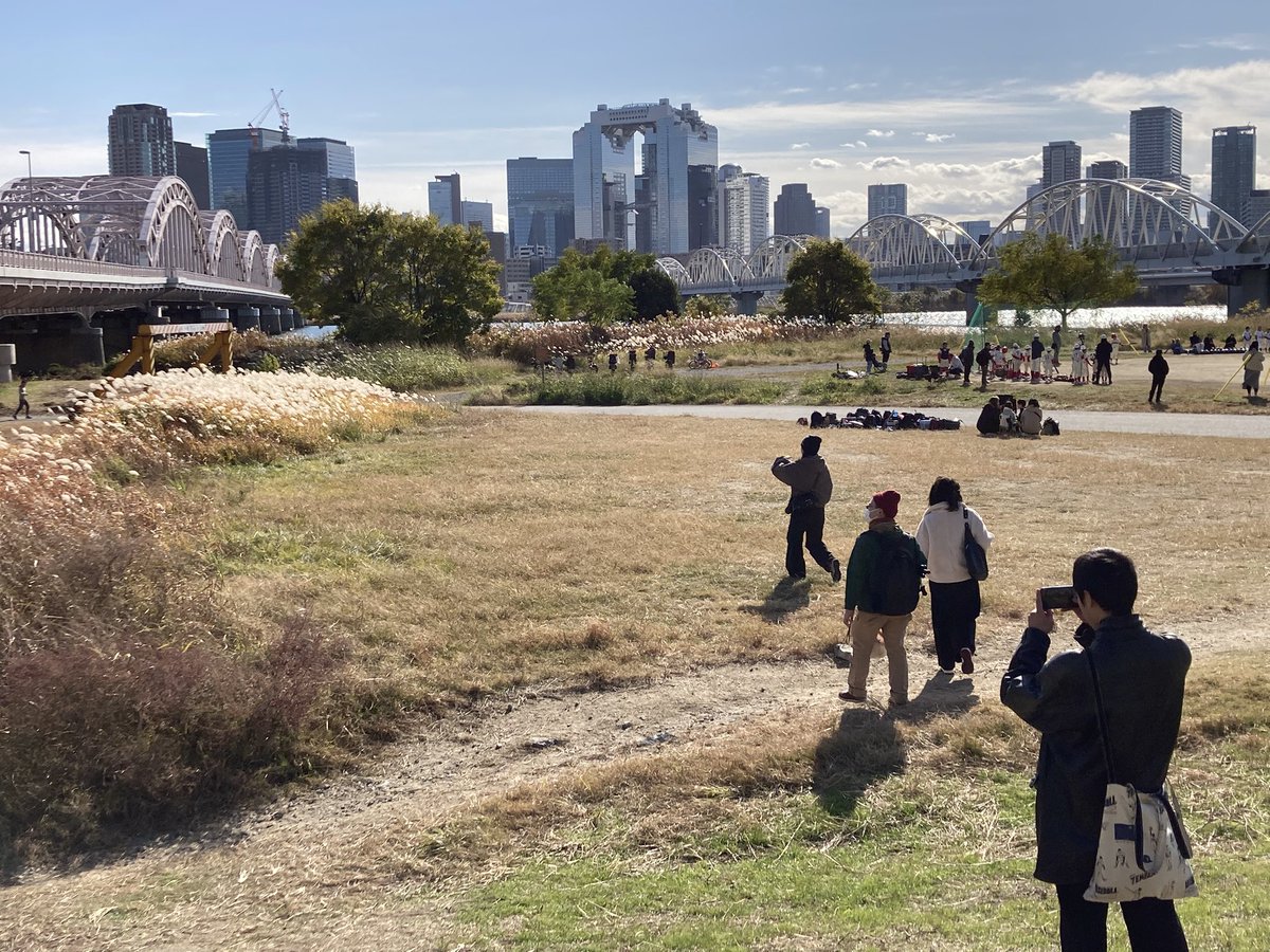 co2_eiga's tweet photo. 第5回シネマ・スコラ。十三大橋にロケハンに来ています。ロケハン日和☀️各自の1分間映画をどの構図で撮ろうかなぁ？と探索中。標準レンズ固定カメラで撮るがルールなので、腕を伸ばして手のひらを広げて、標準レンズの構図を探しています。16mmカメラでも順番で覗いてみています。🐗 https://t.co/OnWnoqz3zQ