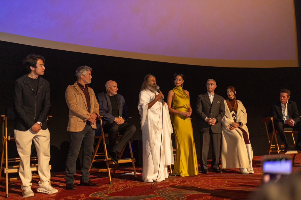 Gurudev's tweet photo. Turn back and see all of life is a drama of so many different emotions. When you are a witness to this, then we operate from another place, one that unites in a world riddled by so many conflicts. Cinema entertains but also steers the mindset of young people. In Hollywood, with industry stalwarts speaking before a global film premiere. @iamredham @Esai_Morales Mark Pennell