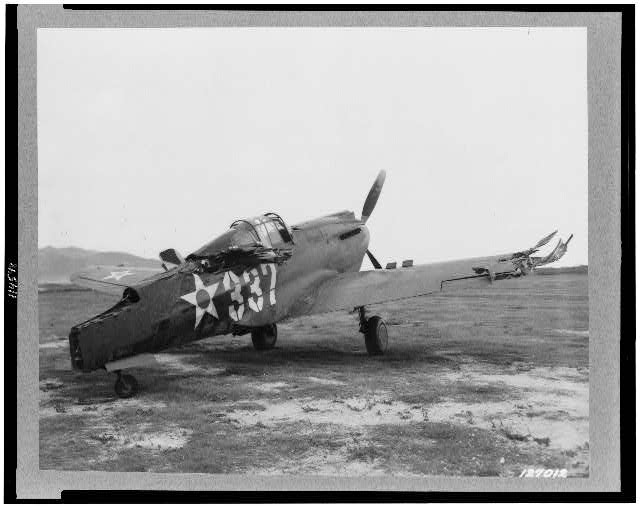 Image shows P-40 aircraft shot on the ground. LOC