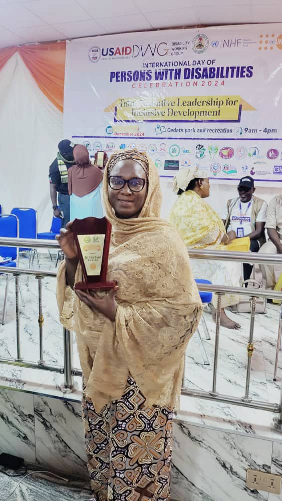 portrait_child's tweet photo. HONORING EXCELLENCE!
Our Executive Director (Dr. Zarah Yusuf Ahmad) was recognized with a prestigious award from Yobe State Disabilities Working Group &amp; Joint National Association of Persons with Disabilities on International Day for Persons with Disabilities! #PLCI https://t.co/eDyyI57sCF