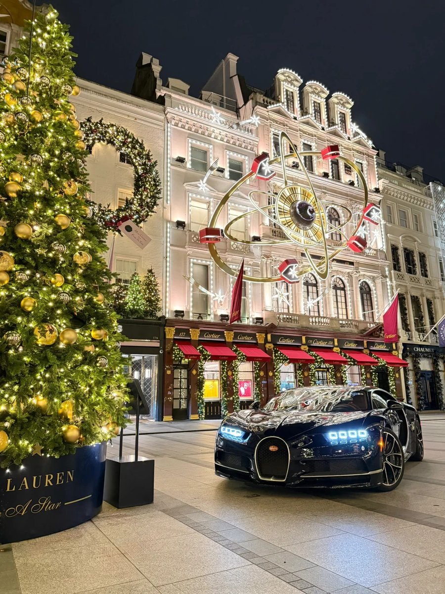 orientalli's tweet image. A night scene featuring a luxurious car underneath stunning street lights shaped like angels, enhancing the festive atmosphere.