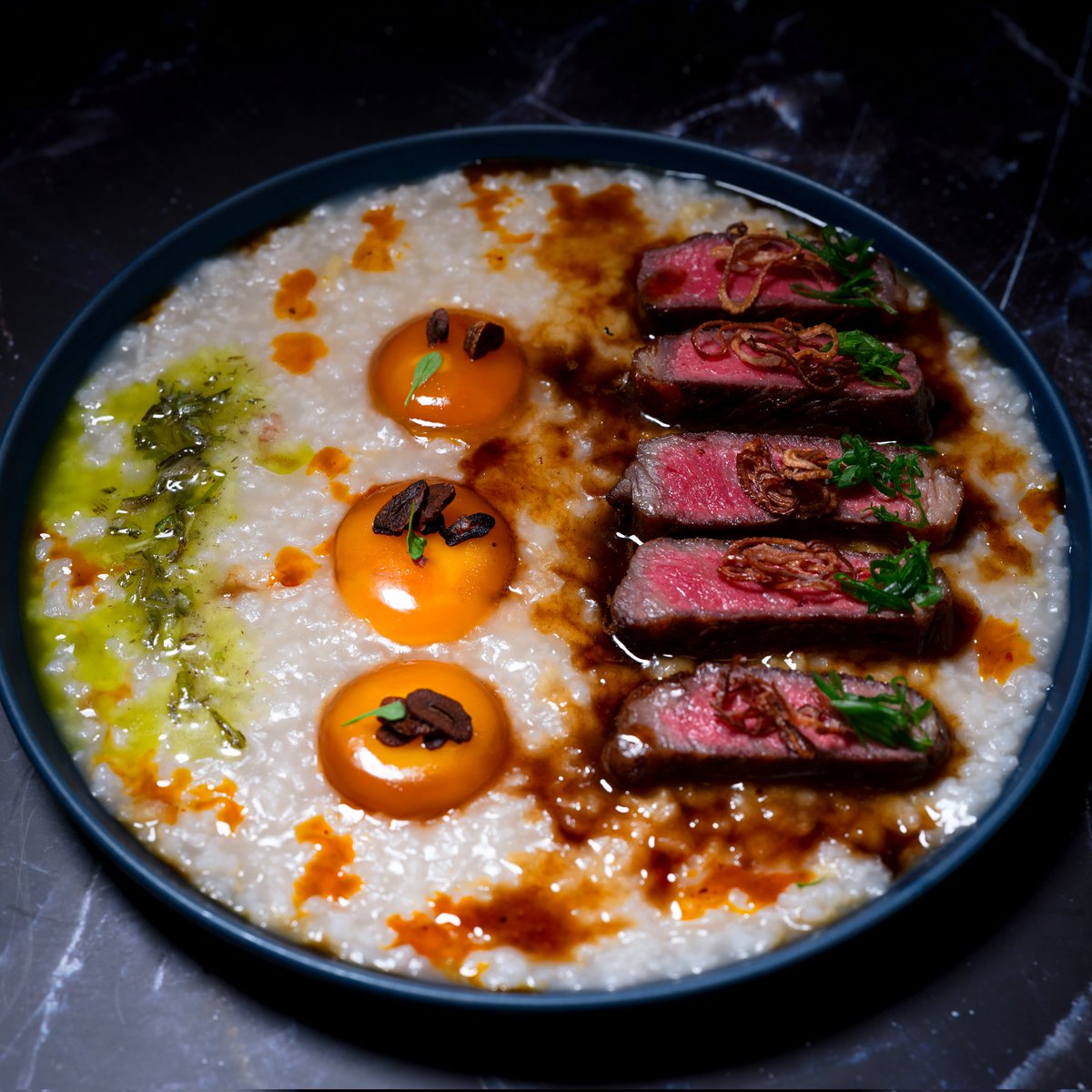 My very first original dish! Steak with a pan sauce teriyaki and Congee, with cured egg yolks and charred green onion vinaigrette+ a lil dash of numbing chili oil. Finsihed with crispy garlic and shallots for texture. #Food #foodphotography #chef