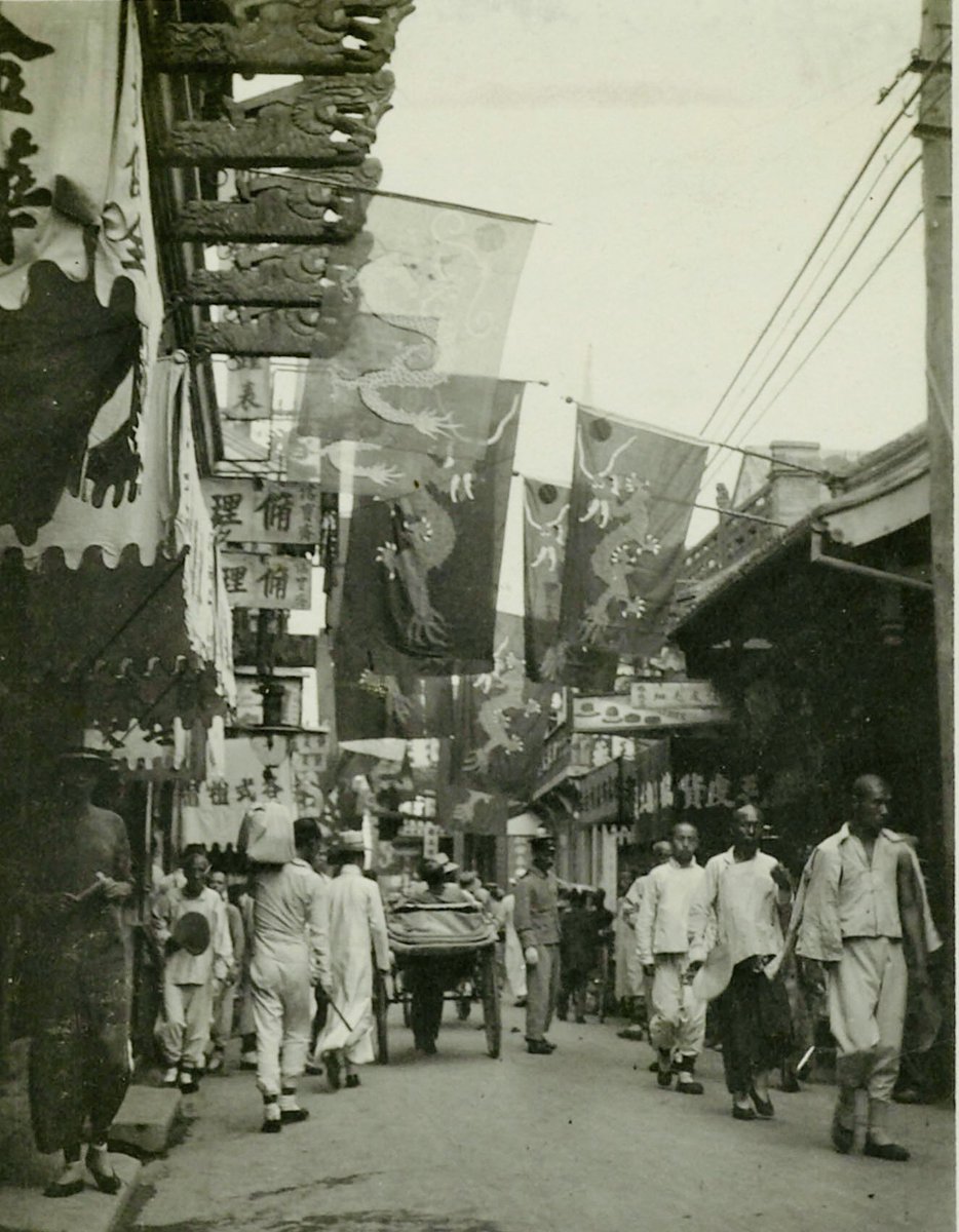 Dragon flags of Imperial Qing in Peking's street, 1917.
An attempt to restore the Chinese monarchy by General Zhang Xun, reinstalled the last emperor Puyi to the throne. The restoration lasted just shy of two weeks, and was quickly reversed by Republican troops.