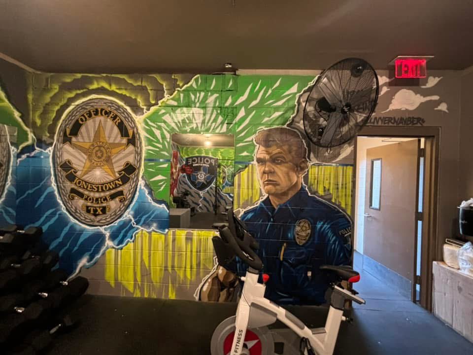 JonestownPolice's tweet photo. We're so excited to share our incredible mural created by the talented Aaron &amp; Cynthia Darling! Their amazing work brought energy &amp; inspiration to our PD gym. A huge thank you to Aaron &amp; Cynthia for their creativity and dedication to making this project so special! #StrengthInArt https://t.co/ri3yDqoWYY