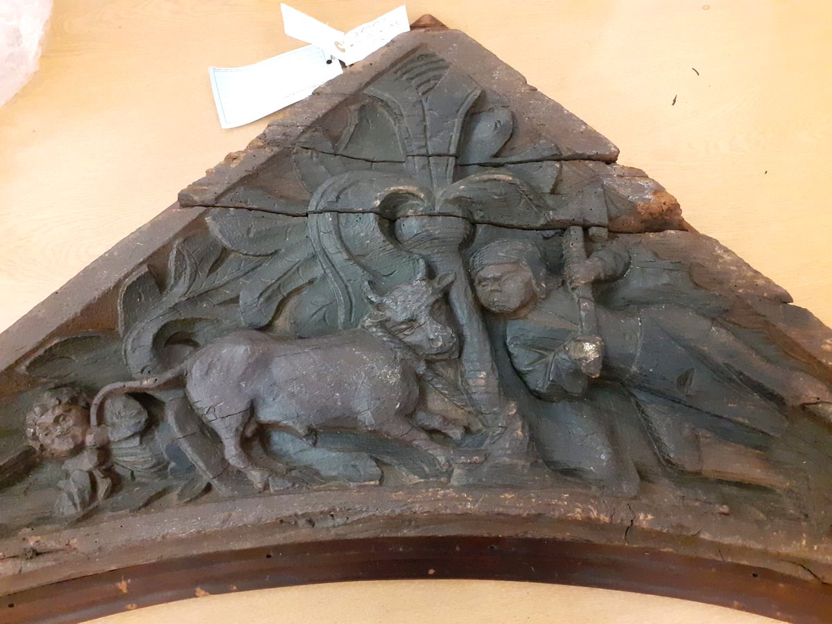 ConservationBob's tweet image. Ipswich Museum Conservation for redevelopment. Michael has been cleaning a medieval spandrel depicting 2 butchers pole axing a bull.  Vacuumed, brushed, wet cleaned and waxed to bring out the colour. The original paint can de seen after cleaning.