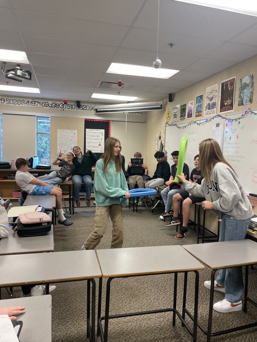 mtd1969's tweet photo. Similar to the sport of chess boxing, students made a boxing ring with desks. There were 3 rounds with 2 minutes of math and 30 seconds of noodle combat per round. Spectators vote on the winner based on questions correct and best body blows. #meimiddle #makingmathfun https://t.co/LIVWL3ufFS
